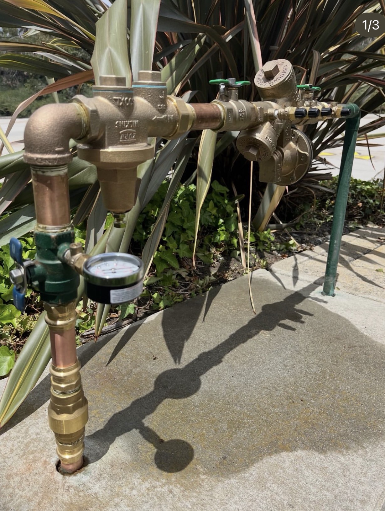 A backflow assembly connected to a pressure test gauge during Mr. Backflow field work